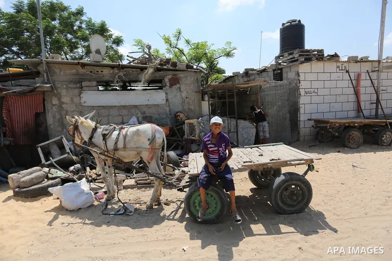 Palestinian children play outside a tin house in an impoverished neighbourhood of the Khan Younis refugee camp in southern Gaza Strip on August 27, 2018. The United States said that it had cancelled more than two hundred...