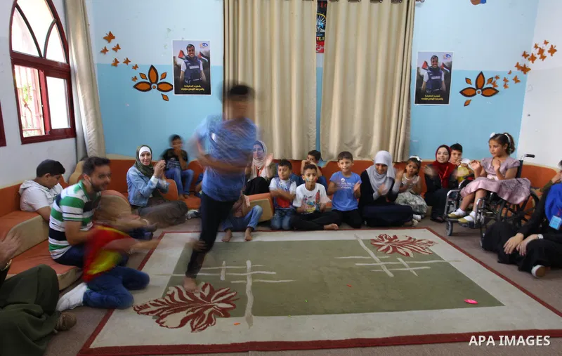 Palestinian children play during the school holiday in Gaza city on August 28, 2018. Photo by Mahmoud Ajour