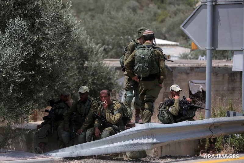 Israeli border policemen take position during a protest by Palestinians in the village of Ras Karkar, near the West Bank city of Ramallah on August 28, 2018. Photo by Shadi Hatem