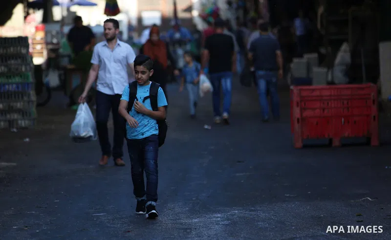 Palestinian students return back to their school in the morning of the first day of the new year study, in the West Bank city of Nablus on August 29, 2018. Photo by Shadi Jarar'ah