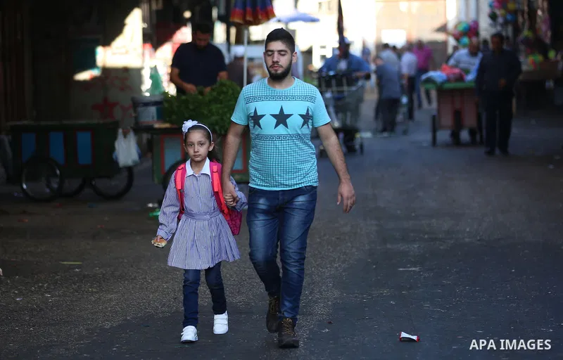 Palestinian students return back to their school in the morning of the first day of the new year study, in the West Bank city of Nablus on August 29, 2018. Photo by Shadi Jarar'ah