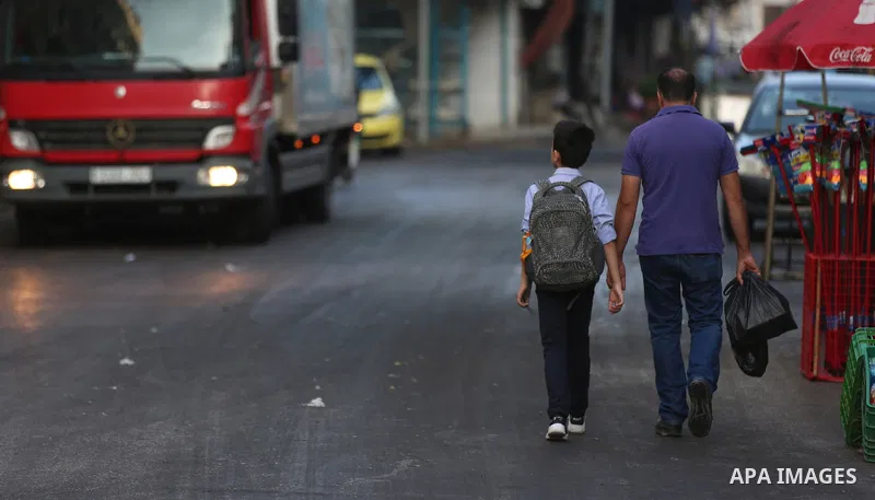 Palestinian students return back to their school in the morning of the first day of the new year study, in the West Bank city of Nablus on August 29, 2018. Photo by Shadi Jarar'ah
