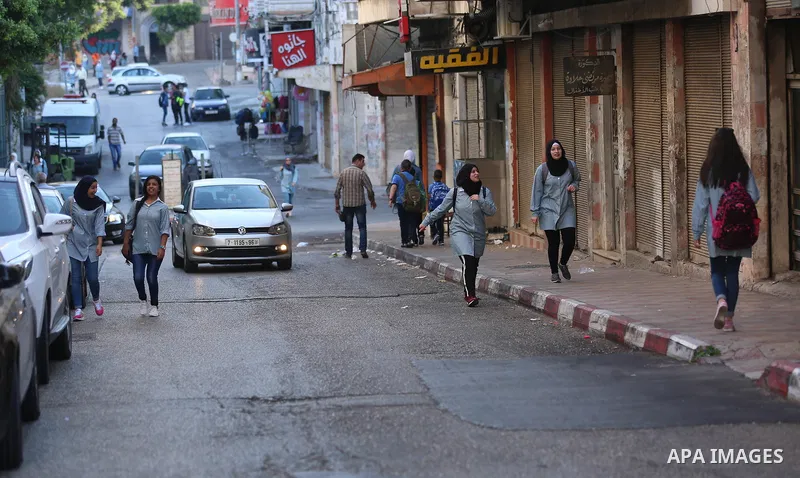 Palestinian students return back to their school in the morning of the first day of the new year study, in the West Bank city of Nablus on August 29, 2018. Photo by Shadi Jarar'ah