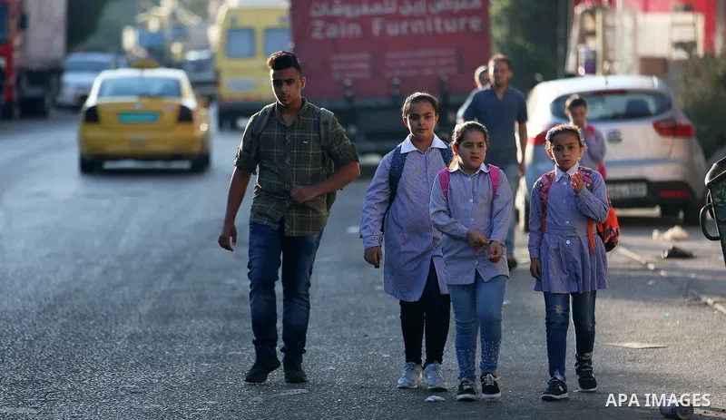 Palestinian students return back to their school in the morning of the first day of the new year study, in the West Bank city of Nablus on August 29, 2018. Photo by Shadi Jarar'ah