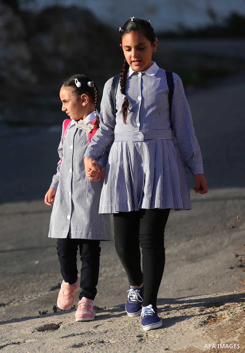 Palestinian students return back to their school in the morning of the first day of the new year study, in the West Bank city of Nablus on August 29, 2018. Photo by Shadi Jarar'ah