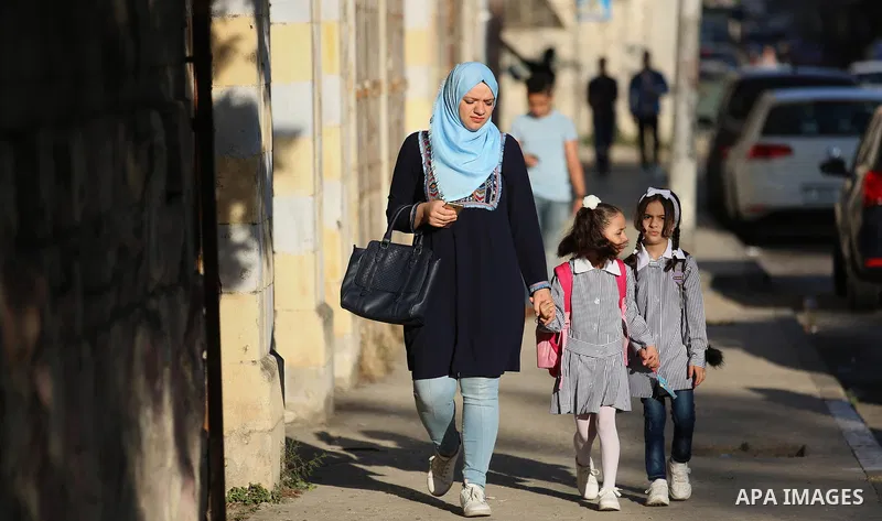 Palestinian students return back to their school in the morning of the first day of the new year study, in the West Bank city of Nablus on August 29, 2018. Photo by Shadi Jarar'ah