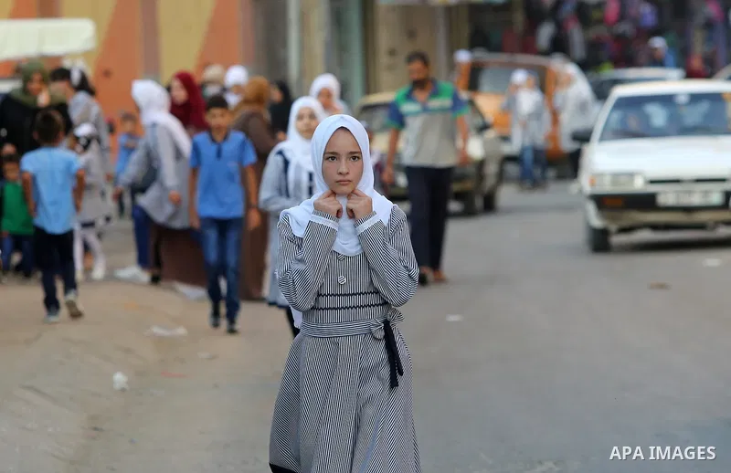 Palestinian students return back to their school in the morning of the first day of the new year study, in Nusseirat refugee camp in the center of Gaza Strip, on August 29, 2018. Photo by Atia Darwish