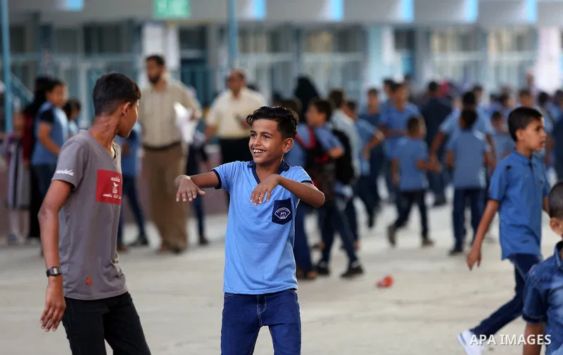 Palestinian students return back to their school in the morning of the first day of the new year study, in Nusseirat refugee camp in the center of Gaza Strip, on August 29, 2018. Photo by Atia Darwish