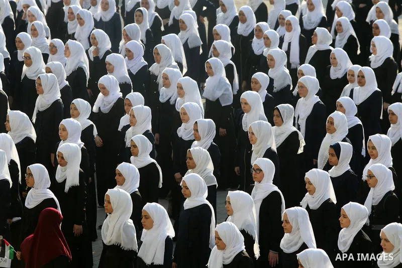 Palestinian schoolgirls take part in the morning exercise inside their school, on the first day of a new school year, in Nusseirat refugee camp in the center of Gaza Strip, on August 29, 2018. Photo by Atia Darwish