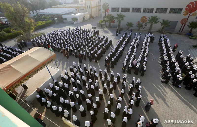 Palestinian schoolgirls take part in the morning exercise inside their school, on the first day of a new school year, in Nusseirat refugee camp in the center of Gaza Strip, on August 29, 2018. Photo by Atia Darwish
