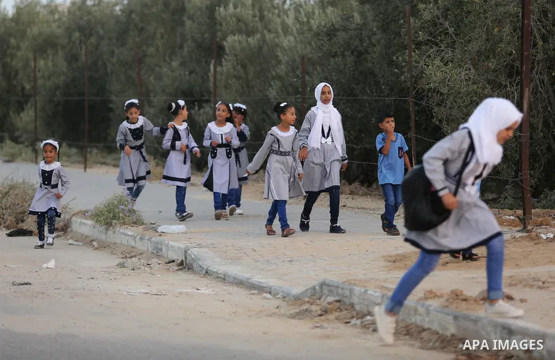 Palestinian students return back to their school in the morning of the first day of the new year study in Deir Al-Balah in the central Gaza Strip, on August 29, 2018. Photo by Ashraf Amra