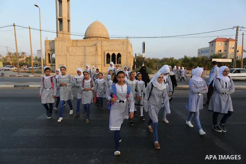 Palestinian students return back to their school in the morning of the first day of the new year study in Deir Al-Balah in the central Gaza Strip, on August 29, 2018. Photo by Ashraf Amra