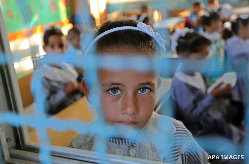 Palestinian students sit inside a classroom at their school belonging to the United Nations Relief and Works Agency for Palestinian Refugees (UNRWA) in Deir Al-Balah in the central Gaza Strip, on August 29, 2018. Photo b...