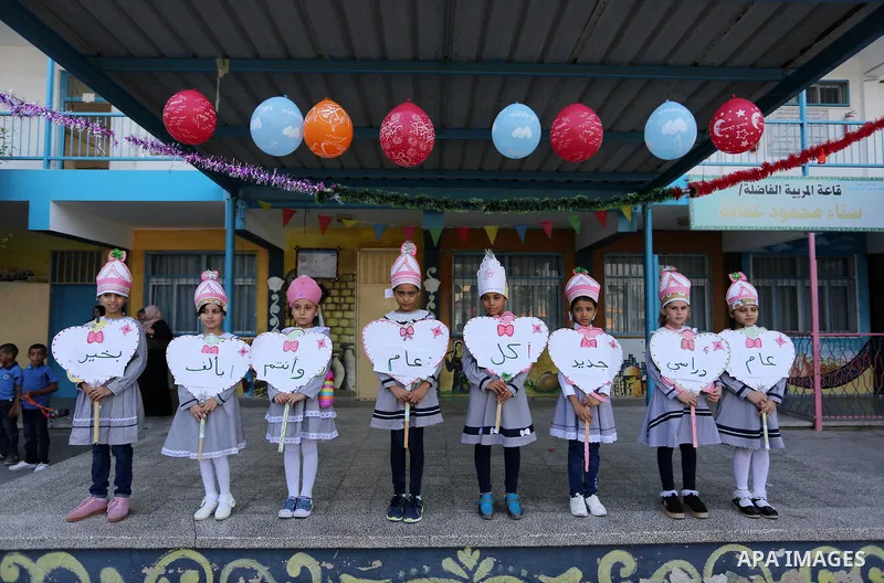 Palestinian students take part in the morning exercise inside their school belonging to the United Nations Relief and Works Agency for Palestinian Refugees (UNRWA) in Deir Al-Balah in the central Gaza Strip, on August 29...