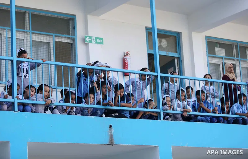 Palestinian students stand outside a classroom at their school belonging to the United Nations Relief and Works Agency for Palestinian Refugees (UNRWA) in Deir Al-Balah in the central Gaza Strip, on August 29, 2018. Phot...