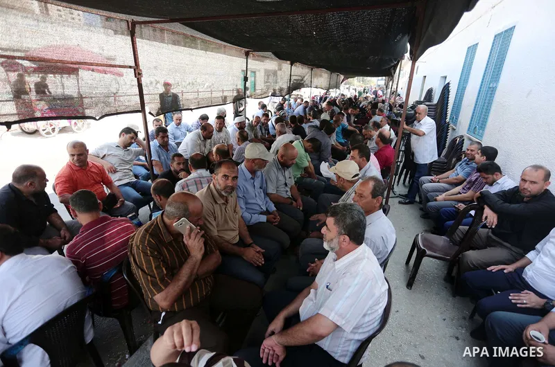 Palestinian employees of United Nations Relief and Works Agency (UNRWA) take part in a protest tent against job cuts announced by the agency, in conjunction with the start of the new school year, outside its headquarter...