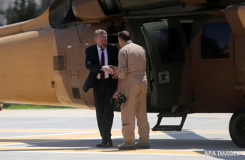 Chairman of the Tripartite Presidency of Bosnia and Herzegovina Bakir Izetbegovic gets off a military helicopter before his meeting with Palestinian President Mahmoud Abbas in the West Bank city of Ramallah on August 29,...