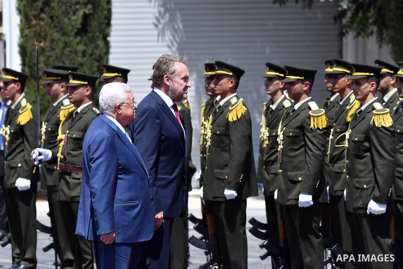Palestinian President Mahmoud Abbas and Chairman of the Tripartite Presidency of Bosnia and Herzegovina Bakir Izetbegovic review the honor guard during a reception ceremony, in the West Bank city of Ramallah on August 29...