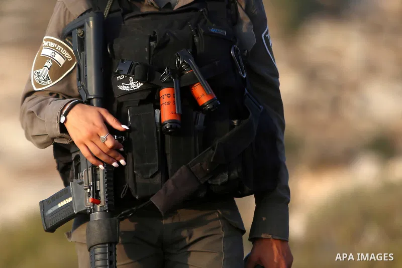 An Israeli troop takes position during clashes with Palestinian protesters following a protest against Jewish settlements in the village of Ras Karkar, near the West Bank city of Ramallah on August 30, 2018. Photo by Sha...