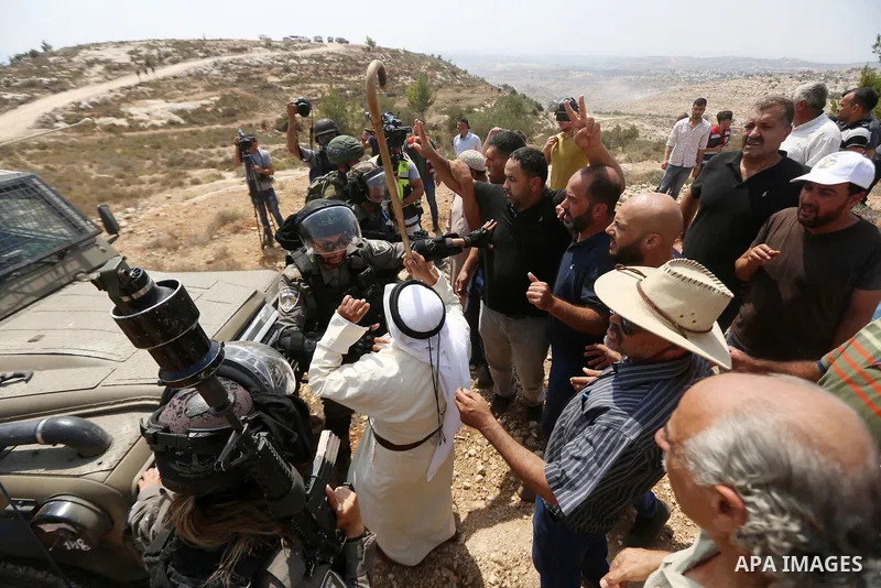 Palestinian protesters scuffle with Israeli border policemen during a protest against Israeli settlement construction, in the village of Ras Karkar, near the West Bank city of Ramallah on August 31, 2018. Photo by Shadi...