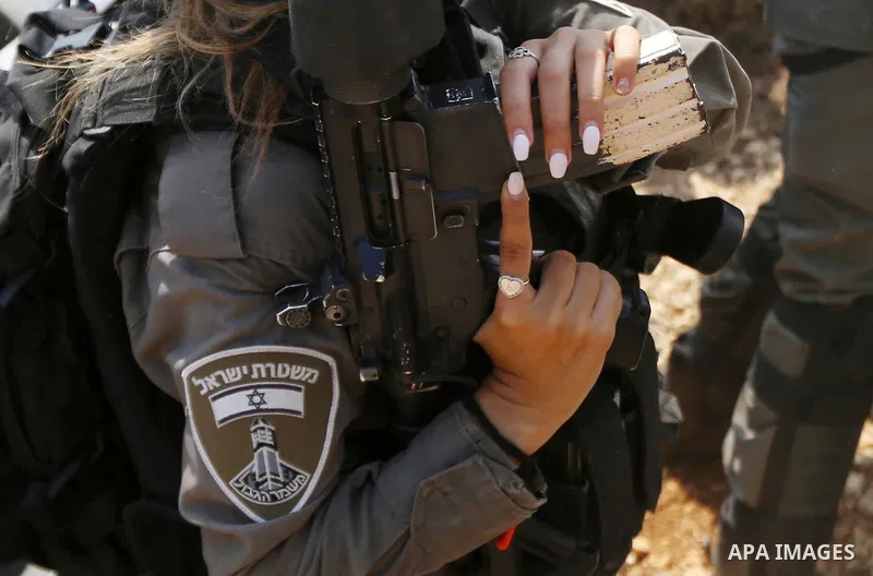 Israeli border policemen take positio druing a protest by Palestinians against Israeli settlement construction, in the village of Ras Karkar, near the West Bank city of Ramallah on August 31, 2018. Photo by Shadi Hatem