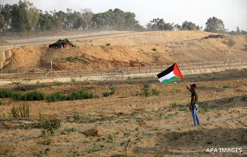 Palestinian protesters gather during clashes with Israeli troops in tents protest where Palestinians demand the right to return to their homeland at the Israel-Gaza border, in al-Bureij in the center of Gaza Strip on Aug...