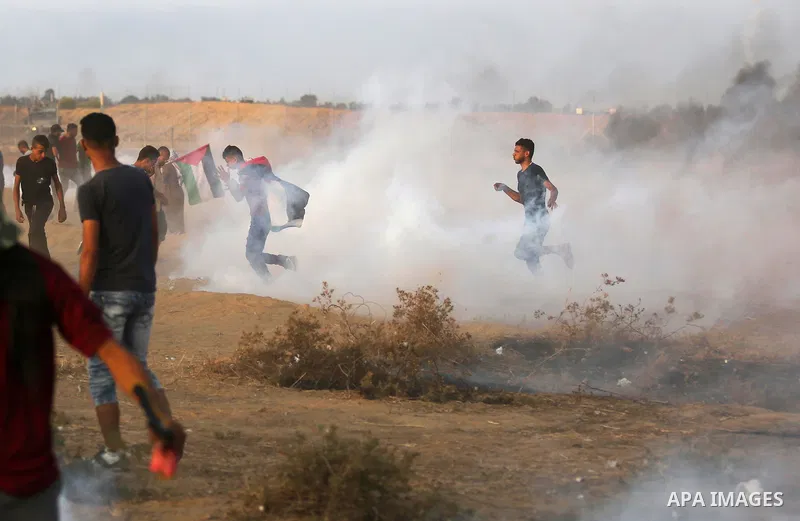 Palestinian protesters gather during clashes with Israeli troops in tents protest where Palestinians demand the right to return to their homeland at the Israel-Gaza border, in Khan Younis in the southern of Gaza Strip on...