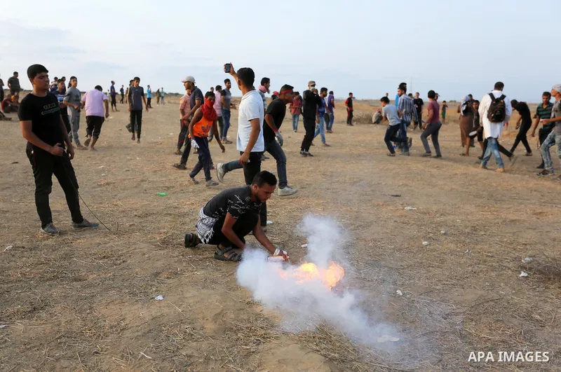 Palestinian protesters gather during clashes with Israeli troops in tents protest where Palestinians demand the right to return to their homeland at the Israel-Gaza border, in Khan Younis in the southern of Gaza Strip on...