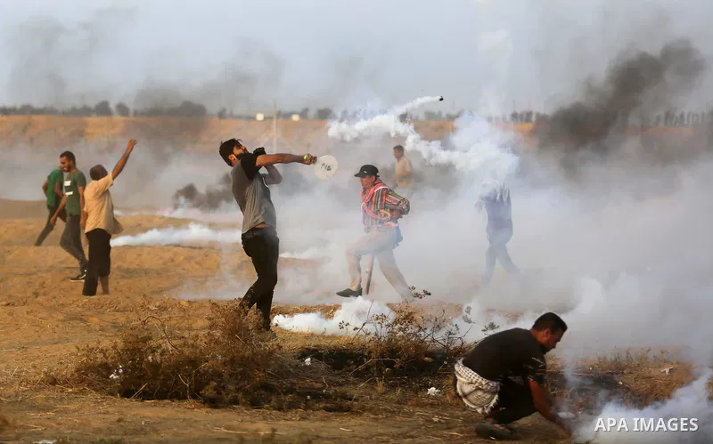 Palestinian protesters gather during clashes with Israeli troops in tents protest where Palestinians demand the right to return to their homeland at the Israel-Gaza border, in Khan Younis in the southern of Gaza Strip on...