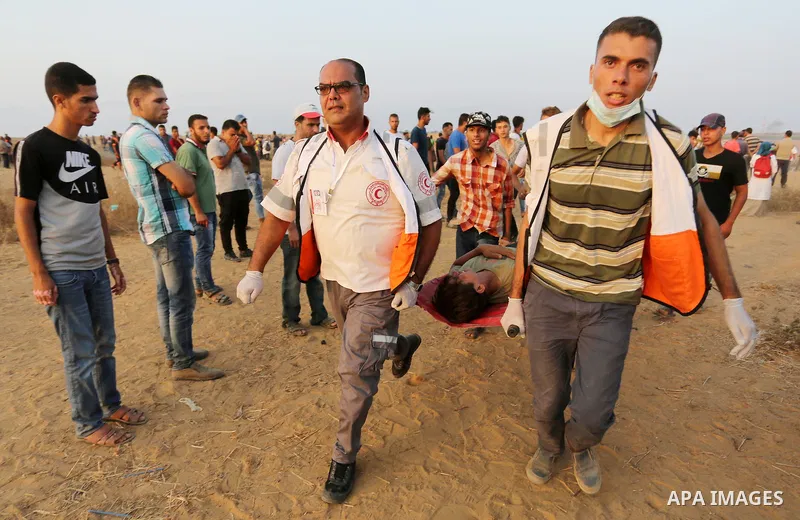 A wounded Palestinian protester is evacuated during clashes with Israeli troops in tents protest where Palestinians demand the right to return to their homeland at the Israel-Gaza border, in Khan Younis in the southern o...