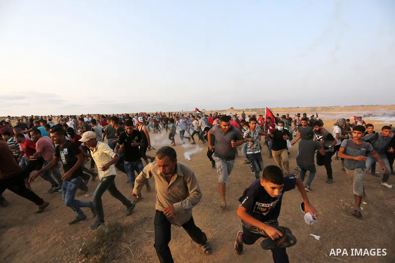 Palestinian protesters gather during clashes with Israeli troops in tents protest where Palestinians demand the right to return to their homeland at the Israel-Gaza border, in Khan Younis in the southern of Gaza Strip on...