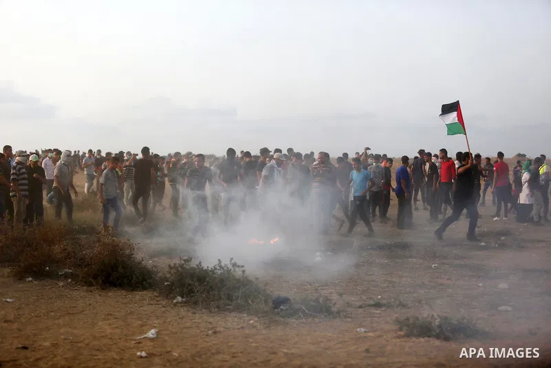 Palestinian protesters gather during clashes with Israeli troops in tents protest where Palestinians demand the right to return to their homeland at the Israel-Gaza border, in Khan Younis in the southern of Gaza Strip on...