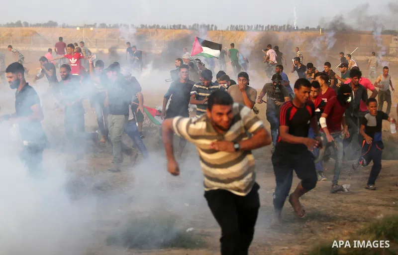 Palestinian protesters gather during clashes with Israeli troops in tents protest where Palestinians demand the right to return to their homeland at the Israel-Gaza border, in Khan Younis in the southern of Gaza Strip on...