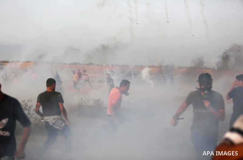 Palestinian protesters gather during clashes with Israeli troops in tents protest where Palestinians demand the right to return to their homeland at the Israel-Gaza border, in Khan Younis in the southern of Gaza Strip on...