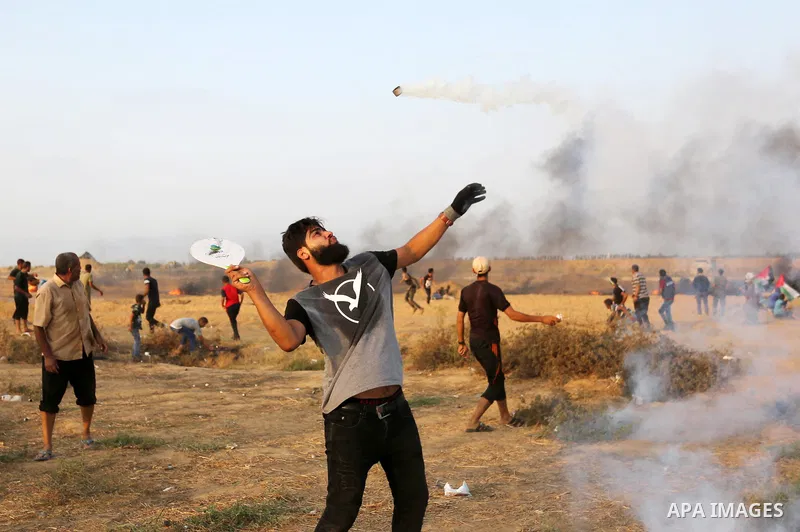 Palestinian protesters gather during clashes with Israeli troops in tents protest where Palestinians demand the right to return to their homeland at the Israel-Gaza border, in Khan Younis in the southern of Gaza Strip on...