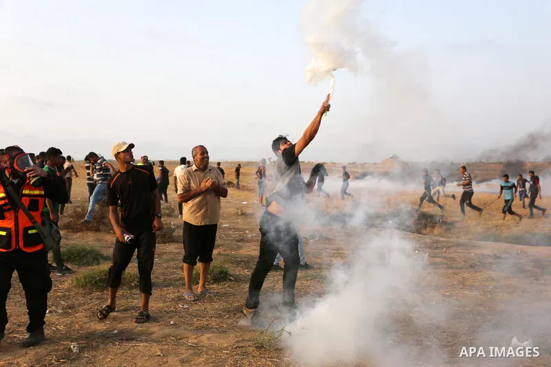Palestinian protesters gather during clashes with Israeli troops in tents protest where Palestinians demand the right to return to their homeland at the Israel-Gaza border, in Khan Younis in the southern of Gaza Strip on...