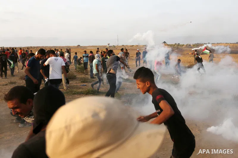 Palestinian protesters gather during clashes with Israeli troops in tents protest where Palestinians demand the right to return to their homeland at the Israel-Gaza border, in Khan Younis in the southern of Gaza Strip on...