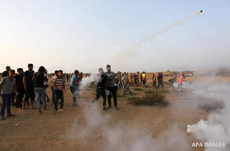 Palestinian protesters gather during clashes with Israeli troops in tents protest where Palestinians demand the right to return to their homeland at the Israel-Gaza border, in Khan Younis in the southern of Gaza Strip on...