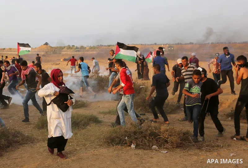 Palestinian protesters gather during clashes with Israeli troops in tents protest where Palestinians demand the right to return to their homeland at the Israel-Gaza border, in Khan Younis in the southern of Gaza Strip on...