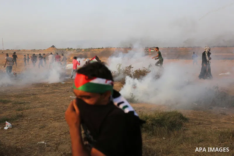 Palestinian protesters gather during clashes with Israeli troops in tents protest where Palestinians demand the right to return to their homeland at the Israel-Gaza border, in Khan Younis in the southern of Gaza Strip on...