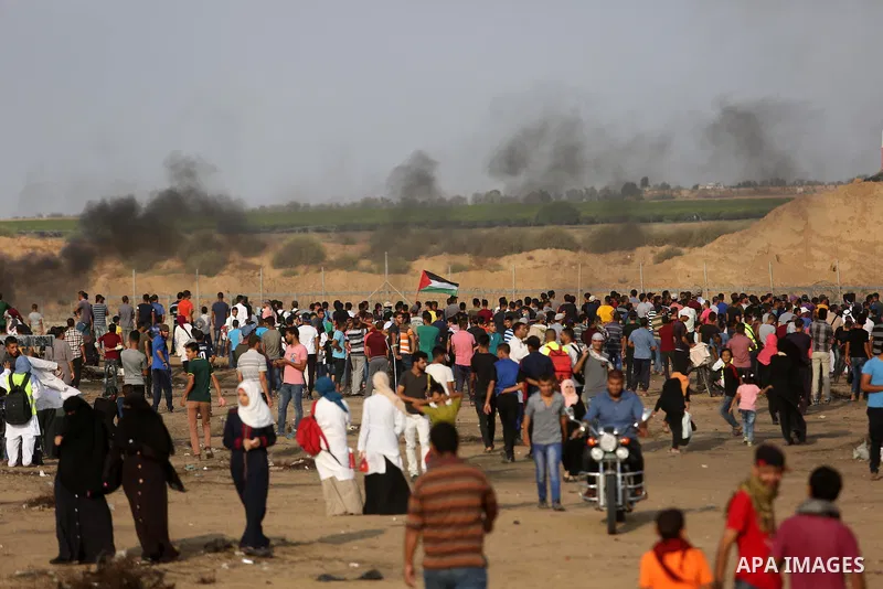 Palestinian protesters gather during clashes with Israeli troops in tents protest where Palestinians demand the right to return to their homeland at the Israel-Gaza border, in Khan Younis in the southern of Gaza Strip on...