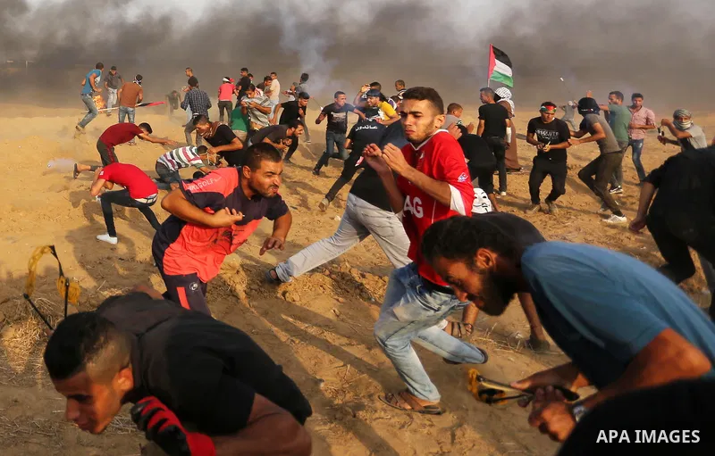 Palestinian protesters gather during clashes with Israeli troops in tents protest where Palestinians demand the right to return to their homeland at the Israel-Gaza border, in Khan Younis in the southern of Gaza Strip on...