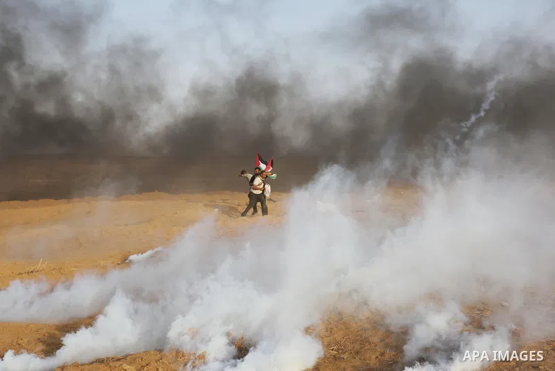 Palestinian protesters gather during clashes with Israeli troops in tents protest where Palestinians demand the right to return to their homeland at the Israel-Gaza border, in Khan Younis in the southern of Gaza Strip on...