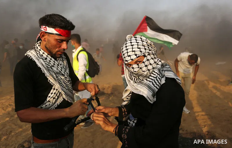 Palestinian protesters gather during clashes with Israeli troops in tents protest where Palestinians demand the right to return to their homeland at the Israel-Gaza border, in Khan Younis in the southern of Gaza Strip on...