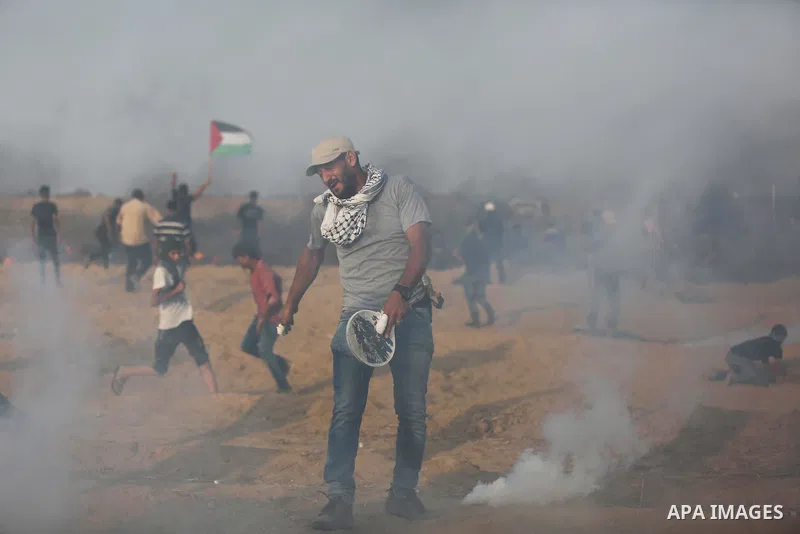 Palestinian protesters gather during clashes with Israeli troops in tents protest where Palestinians demand the right to return to their homeland at the Israel-Gaza border, in Khan Younis in the southern of Gaza Strip on...