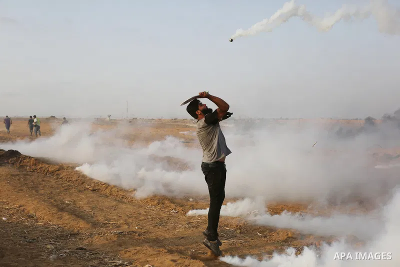 Palestinian protesters gather during clashes with Israeli troops in tents protest where Palestinians demand the right to return to their homeland at the Israel-Gaza border, in Khan Younis in the southern of Gaza Strip on...