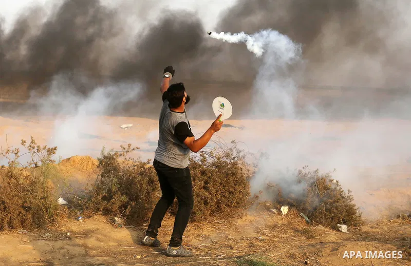Palestinian protesters gather during clashes with Israeli troops in tents protest where Palestinians demand the right to return to their homeland at the Israel-Gaza border, in Khan Younis in the southern of Gaza Strip on...