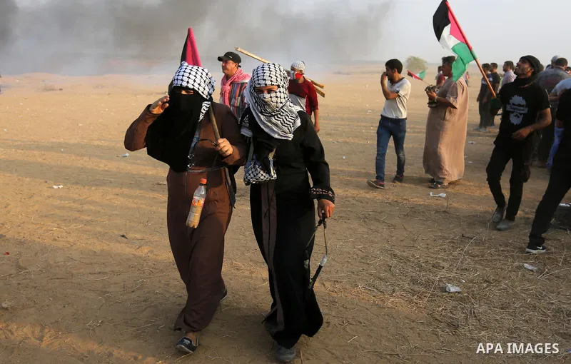 Palestinian protesters gather during clashes with Israeli troops in tents protest where Palestinians demand the right to return to their homeland at the Israel-Gaza border, in Khan Younis in the southern of Gaza Strip on...
