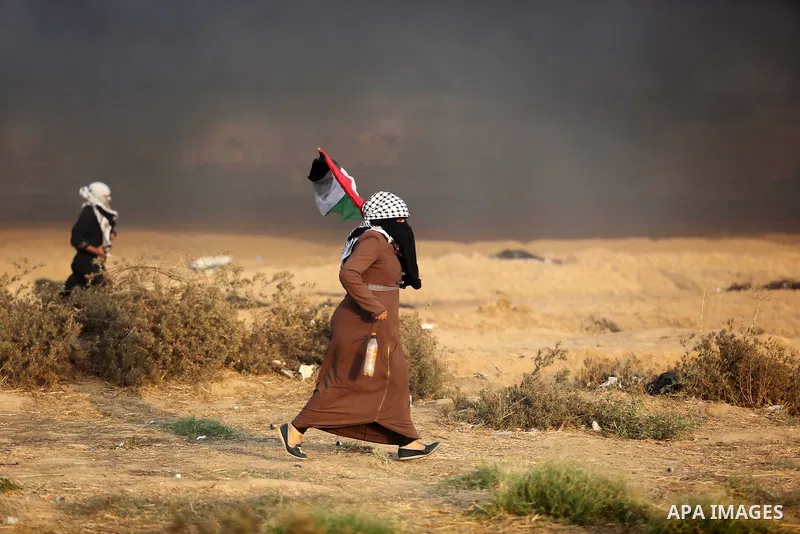 Palestinian protesters gather during clashes with Israeli troops in tents protest where Palestinians demand the right to return to their homeland at the Israel-Gaza border, in Khan Younis in the southern of Gaza Strip on...