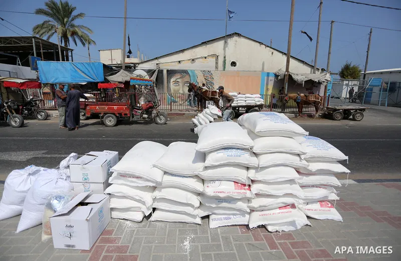 Palestinians stand outside an aid distribution center run by United Nations Relief and Works Agency (UNRWA) in Deir al-Balah in the center of Gaza Strip on September 1, 2018. The United States on Friday halted all fundin...